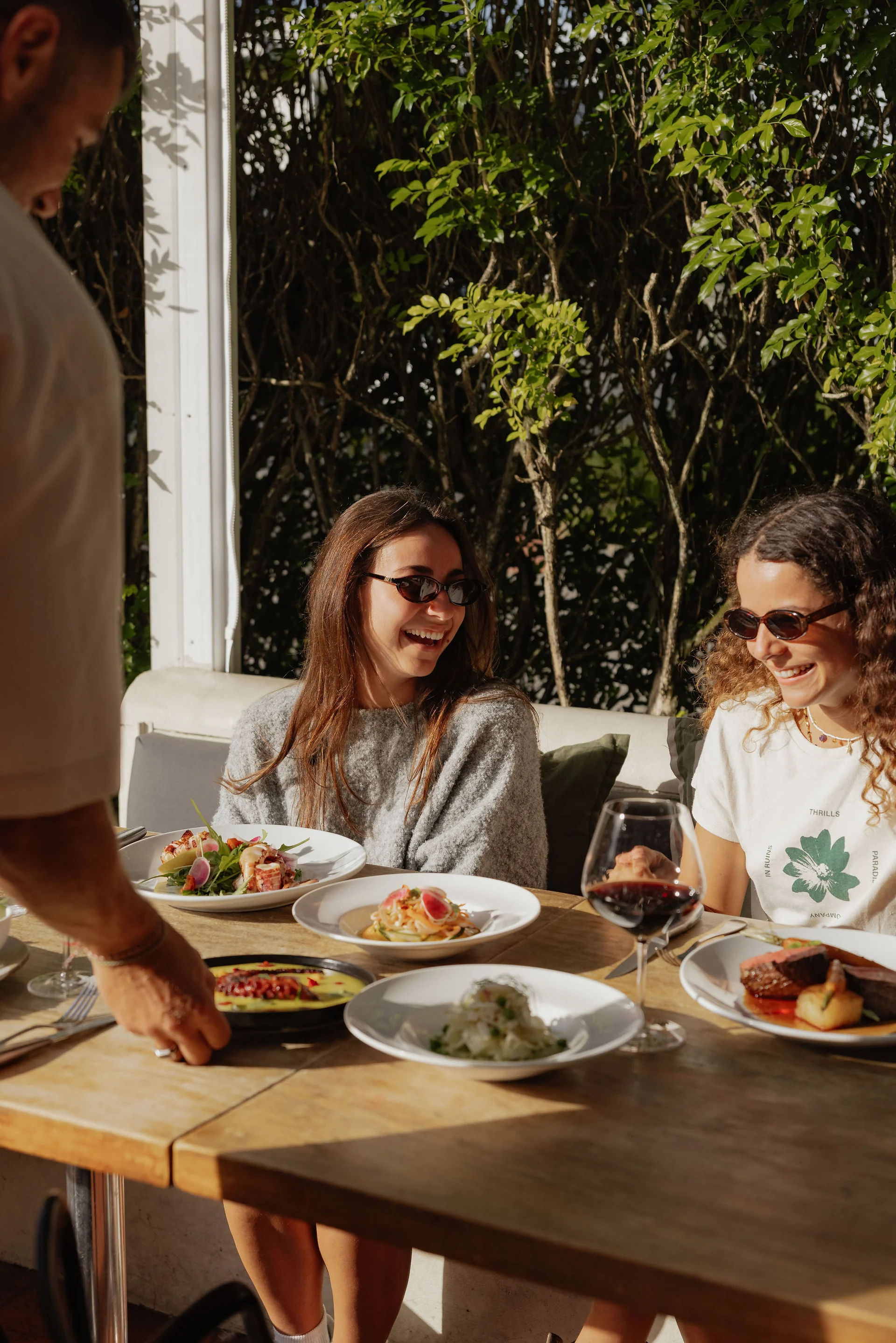 Friends enjoying food and conversation on the terrace